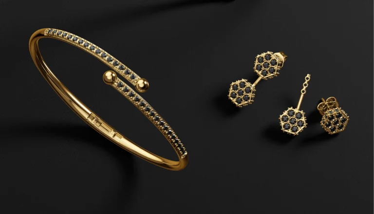 Gold bangle and matching geometric earrings with black gemstones displayed on a dark textured background.