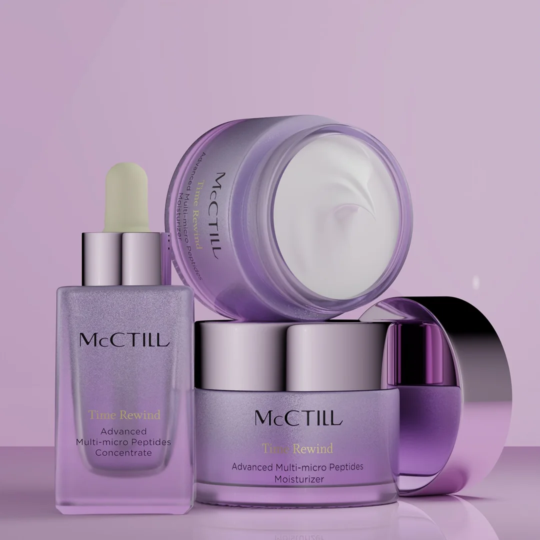 A three-piece skincare collection featuring a serum bottle and two cream jars stacked into a pyramid shape on a reflective purple floor