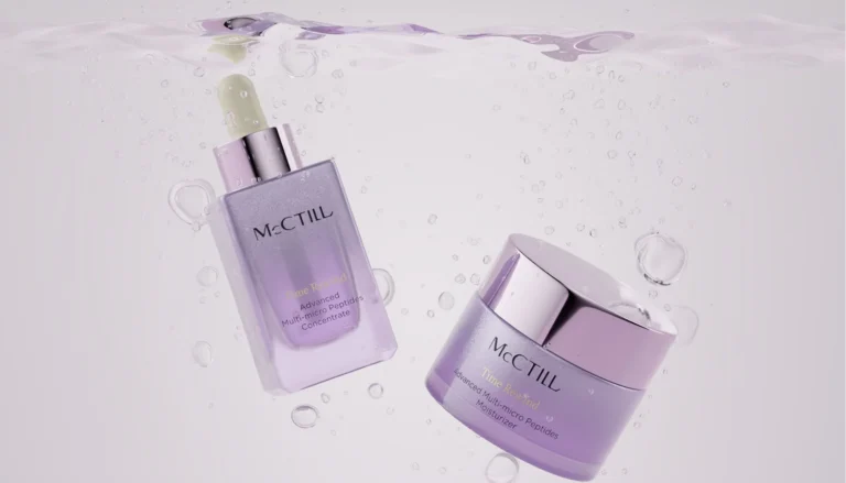 A purple serum bottle and a matching cosmetic jar floating submerged underwater with clear, active air bubbles on a light pastel purple background