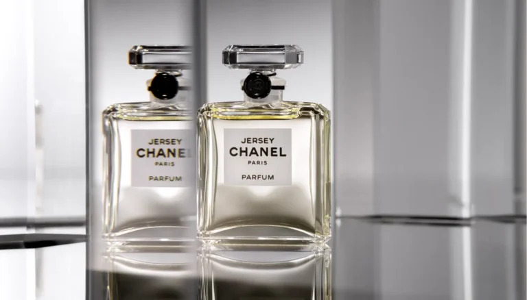 Elegant Chanel Jersey perfume bottle on a reflective surface demonstrating high-end fragrance photography.