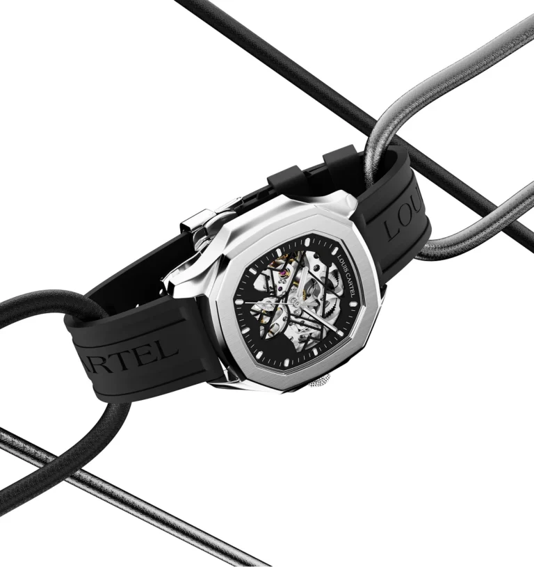 A silver and black skeleton wrist watch suspended diagonally between crossing black cables against a solid white backdrop.